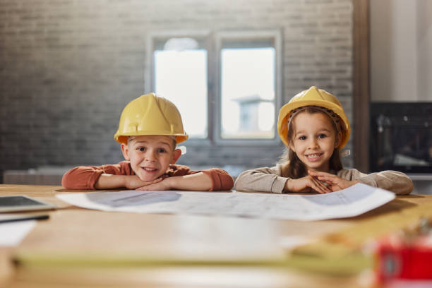 istock Happy little architects with hardhats at renovating house. 1492207458