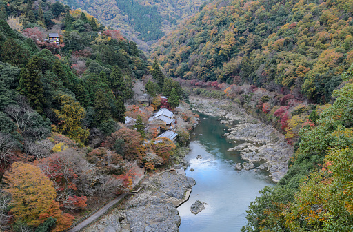 Stunning autumn color landscape of Asashiyama mountain and Hozugawa river in Kyoto, Japan