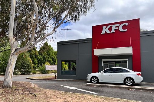 Canberra - Mar 14 2023:Vehicle in KFC restaurant drive-through. In recent years, drive-through restaurants have faced increased scrutiny due to the higher levels of emissions that they create.