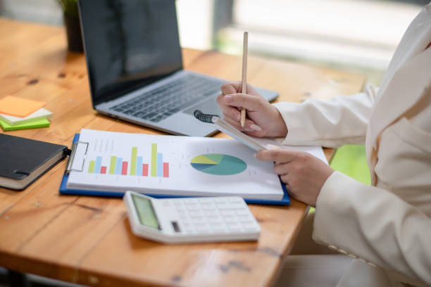 istock business women checking  plan business and take a note. analyzing the financial report. Economic business discussions. 1492211698