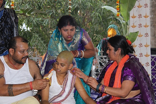 Upanayana, Hindu ritual of initiation, restricted to the three upper varnas, or social classes, that marks the male child’s entrance upon the life of a student (brahmacharin) and his acceptance as a full member of his religious community. The ceremony is performed between the ages of 5 and 24, the wide variance reflecting the different educational requirements of the three upper classes—Brahmans (priests and teachers), Kshatriyas (warriors and rulers), and Vaishyas (merchants and tradesmen).