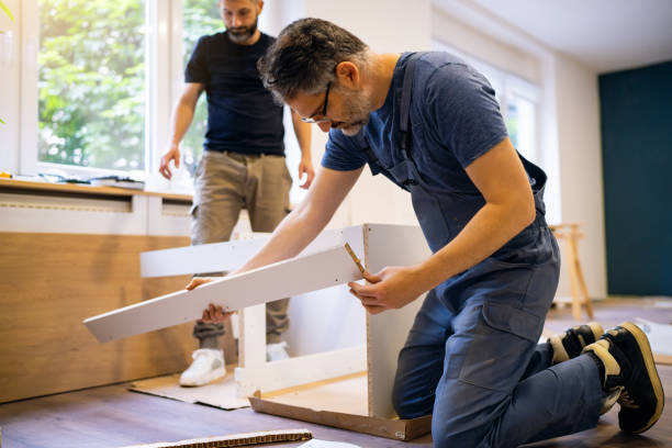 istock Handyman assembling kitchen parts while house owner observing the renovation process 1492216085