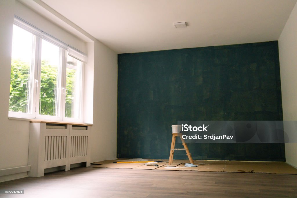 New apartment with a dark blue painted wall New apartment with a dark blue painted wall
Home renovation Paint Stock Photo
