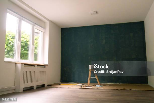 New Apartment With A Dark Blue Painted Wall Stock Photo - Download Image Now - Paint, Drying, Wall - Building Feature