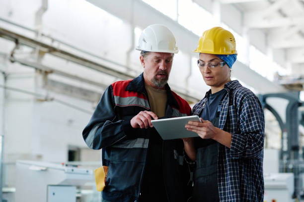 istock Colleagues working on tablet pc in factory 1492217969
