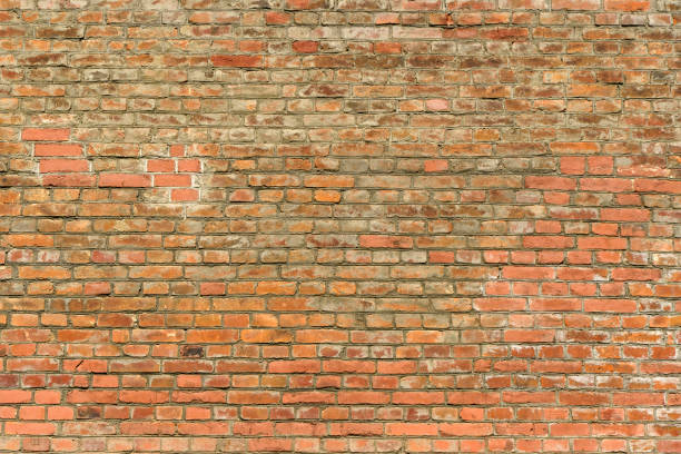 istock Old brick wall. Brickwork from an old brick in a rustic style. The structure and pattern of the destroyed stone wall. Copy space 1492219571