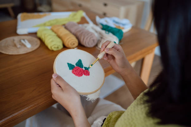 istock Punch needle. Asian Woman making handmade Hobby knitting in studio workshop. designer workplace Handmade craft project DIY embroidery concept. 1492220568