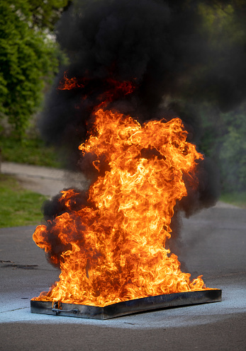 Fire extinguisher demonstration with burning fire