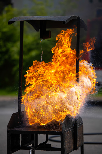 Fire extinguisher demonstration with burning fire