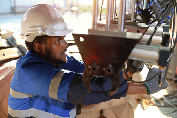 istock Professional heavy industry technician engineer in safety workwear maintenance and check part of robot arm machine in intelligent factory automotive. Industrial and technology support system concept 1492221173
