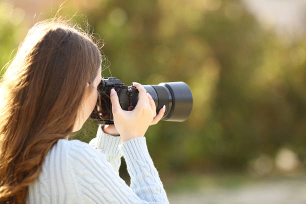 istock Photographer taking photos with mirrorless camera 1492222999