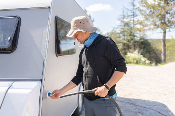 istock Man Filling Caravan Tank With Water 1492230253