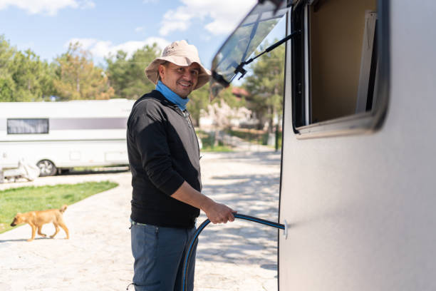 istock Man Filling Caravan Tank With Water 1492230344