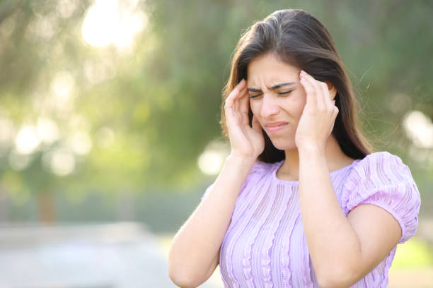 istock Woman suffering migraine in a park 1492239875