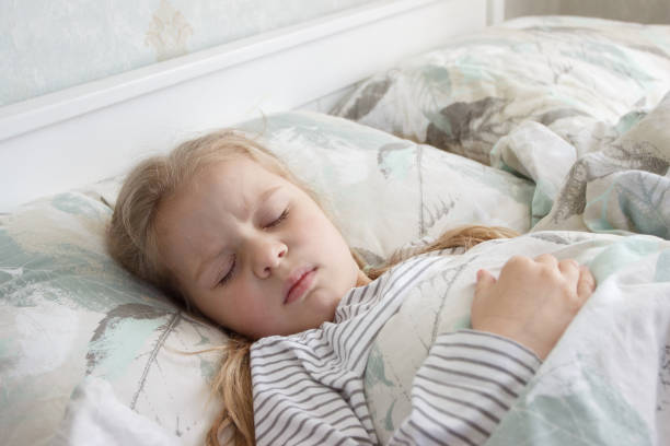 istock Little cute kid sleeping in the bed. Concept of resting 1492240340