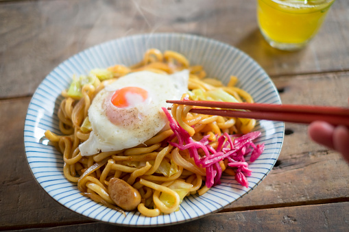 Japanese fried udon noodle with a fried egg on top.