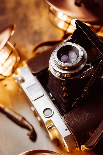 An old medium format camera with bellows lens from the 1940-50s flat lay.