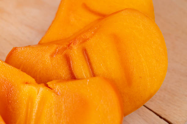 istock Sliced ripe orange pitted persimmon 1492246675