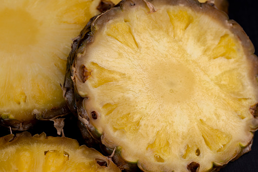 sliced pulp of peeled ripe pineapple , sweet delicious yellow pineapple cut into pieces