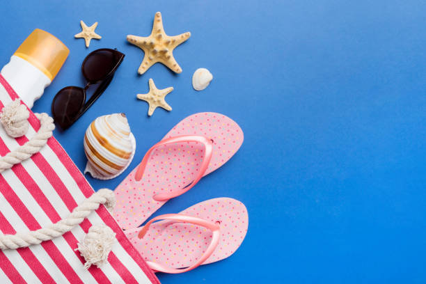 istock beach accessories flat lay top view on colored background Summer travel concept. Bag with starfish and sea shell. Top view 1492256206