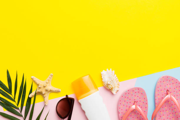 istock Summer vacation accessories, sunglasses, flip-flops, sunscreen colored background. Traveling essentials flat lay with copy space 1492256238