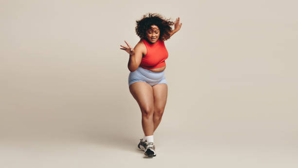 istock Confident body moves: Plus size woman having fun with her body in a dance workout 1492258726
