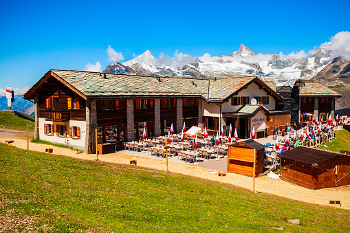 ZERMATT, SWITZERLAND - JULY 16, 2019: Cable car station and street cafe located near Zermatt town in the Valais canton of Switzerland