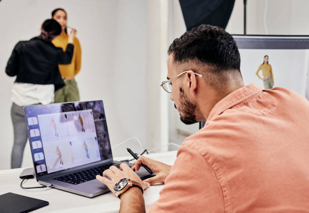 istock Photographer, laptop and editing photography with man in creative studio and check work with creativity. Commercial photoshoot, person retouching and artistic process with focus, screen and digital 1492264393