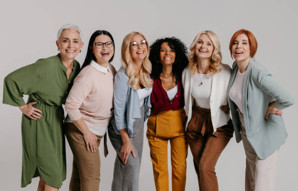 istock Multi-ethnic group of happy mature women bonding against grey background 1492267709