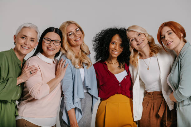 istock Multi-ethnic group of beautiful mature women bonding and smiling against grey background 1492268310