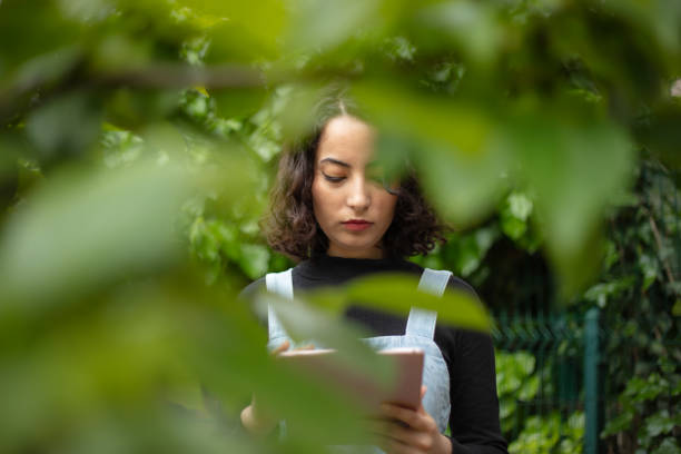 Young woman is using  technology for sustainable agriculture.