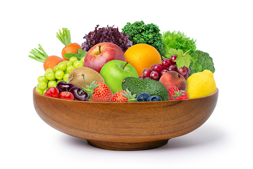 Various types of fruits and vegetables in wooden bowl isolated on white background.