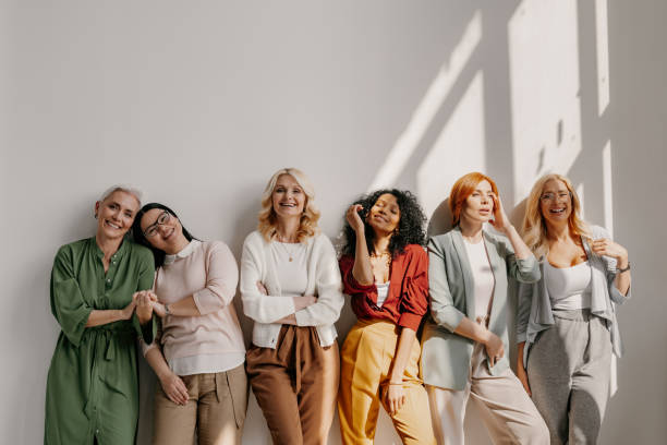 istock Multi-ethnic group of relaxed mature women bonding and smiling while leaning on the wall 1492269030
