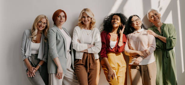 istock Multi-ethnic group of relaxed mature women bonding and smiling while leaning on the wall 1492269034