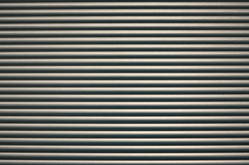 Gray corrugated metal wall. Template for background and texture. Stripes.