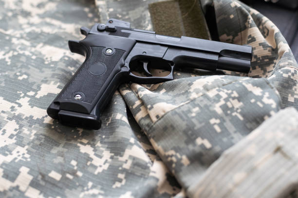 istock Military uniform, tag and gun on color background 1492278418