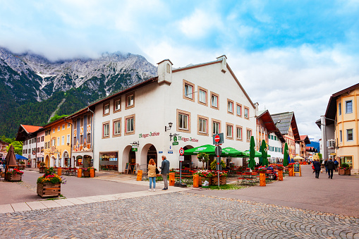 Mittenwald, Germany - July 01, 2021: Beauty local houses in Mittenwald old town in Bavaria, Germany