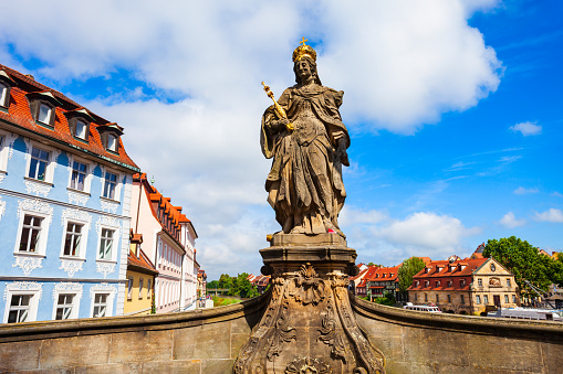 Bamberg, Germany - July 12, 2021: Empress Kaiserin Kunigunde Statue at Untere Brucke Bridge in Bamberg old town. Bamberg is a town on the river Regnitz in Bavaria, Germany