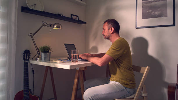 istock Man working on a laptop at home. 1492283140