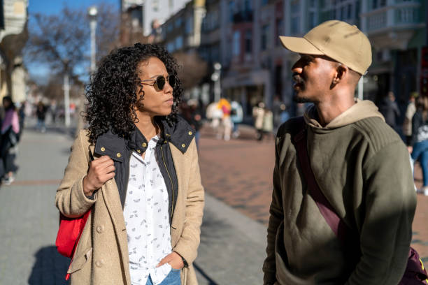 istock Afro couple walking on city streets and talking. 1492283198