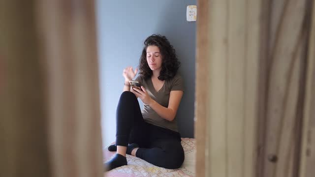 Anxious woman with cell phone