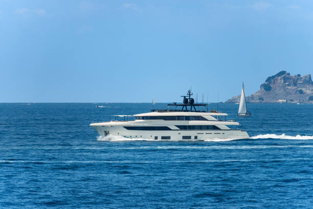 Luxury Yacht in Motion in the Sea - Gulf of La Spezia Liguria Italy La Spezia, Italy - July 23, 2022: White luxury yacht and a sailing boat in motion on Mediterranean sea in front of the Palmaria and Tino islands on a sunny summer day, Porto Venere or Portovenere, Gulf of La Spezia, La Spezia, Liguria, Italy, southern Europe. yacht antenna stock pictures, royalty-free photos & images