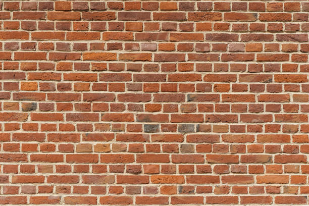 istock Brick wall. Brickwork from an old brick in a rustic style. Structure and pattern of the destroyed stone wall. Copy space 1492285200