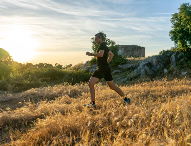 Two men doing trail running. Évora, Portugal, May 22, 2023. Two men, one with gray hair, glasses and the other bald, dressed in running clothes doing trail running. trailblazing stock pictures, royalty-free photos & images