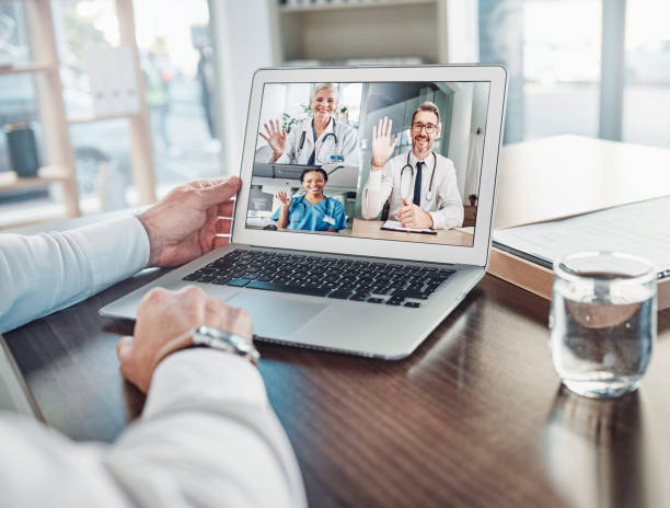 istock Online meeting, video call or doctors wave on laptop for webinar, virtual communication in hospital. Support, healthcare or medical worker discussing medicine, treatment or telehealth on computer 1492288955