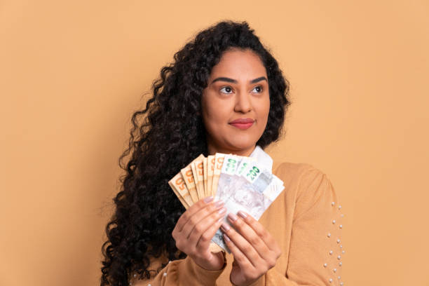 istock woman with brazil banknotes currency 1492288977