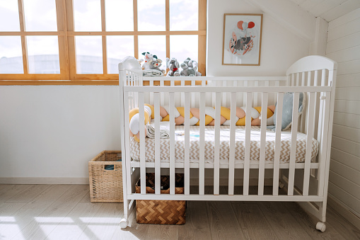 Baby crib with no people in modern cozy bedroom