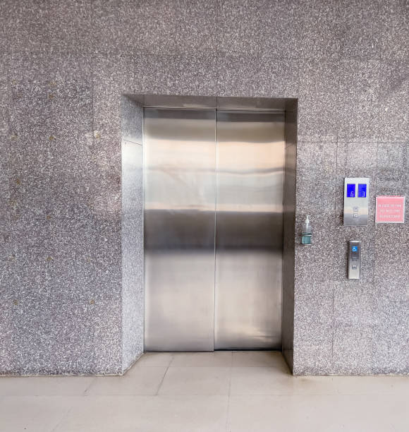 istock The elevator used to go up and down the gray building, the elevator door is shiny.  With push button up and down button and push button for the disabled  gray elevator with gray interior. 1492289132