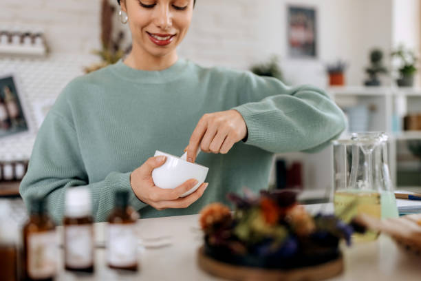 istock Young female small business owner working at her home based cosmetic workshop 1492291086
