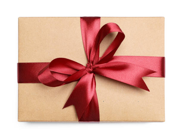 istock Christmas gift in kraft box with red ribbon isolated on white, top view 1492291355